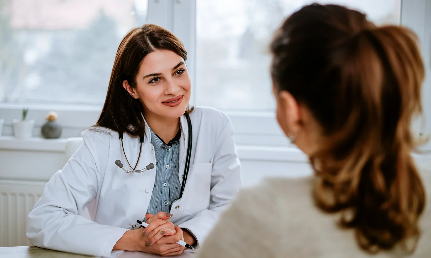 Physician speaking with patient in her office