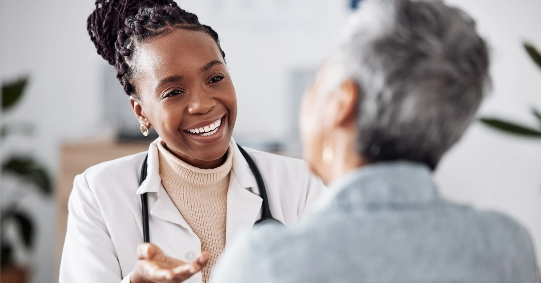 Female doctor talking with her patient in her office