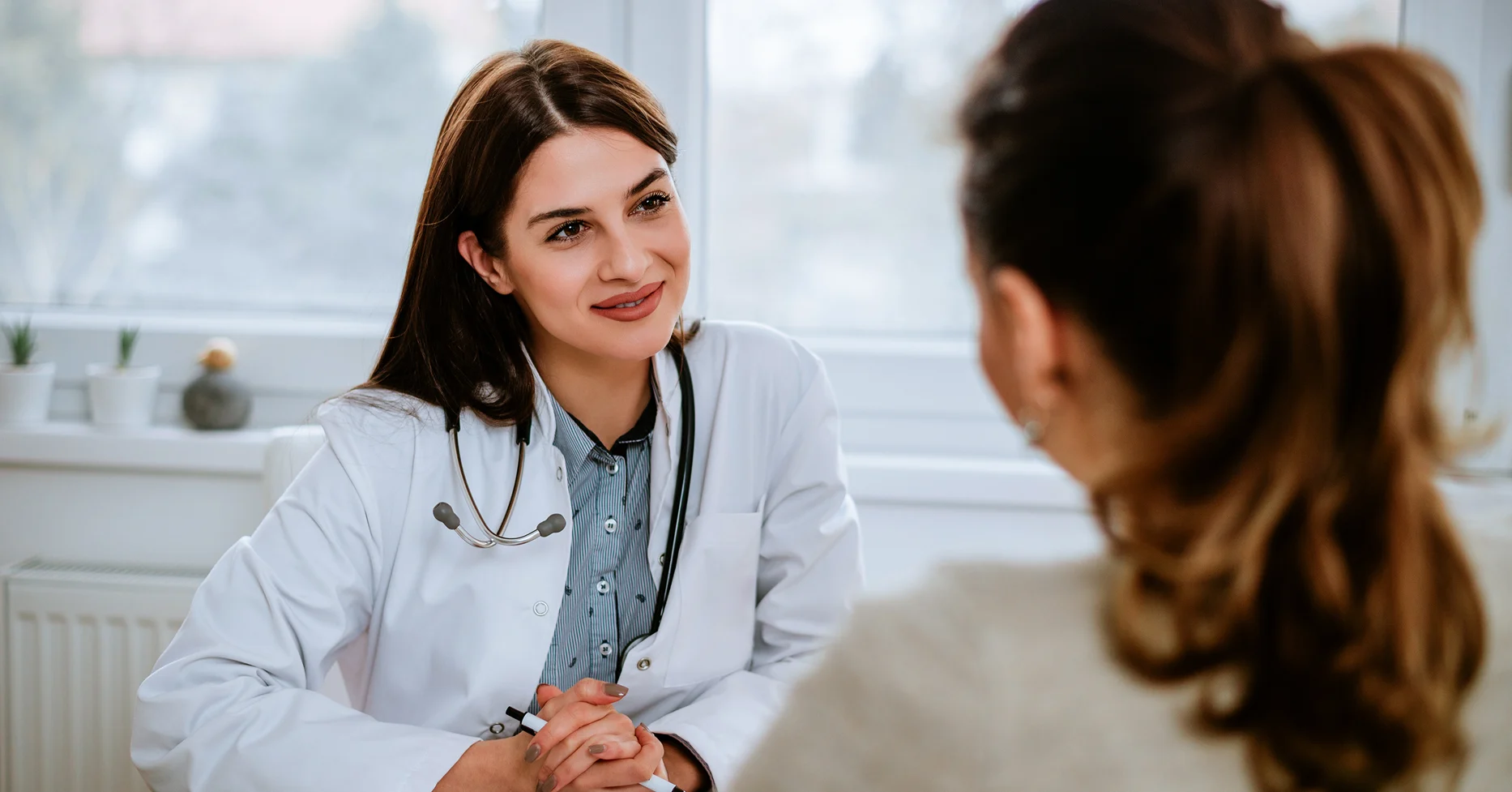 Physician speaking with patient in her office
