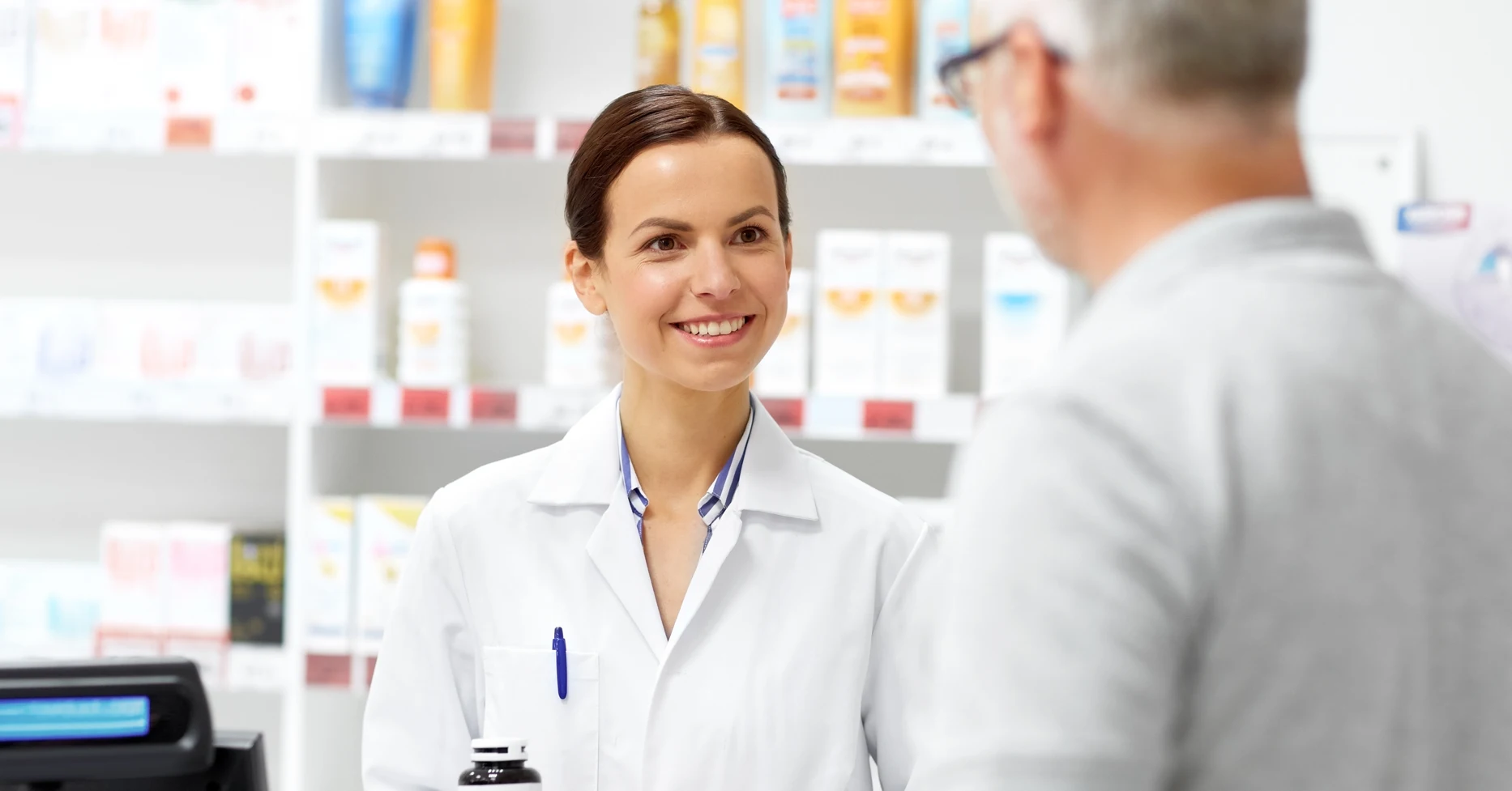 Pharmacist explaining medicine to patient in pharmacy
