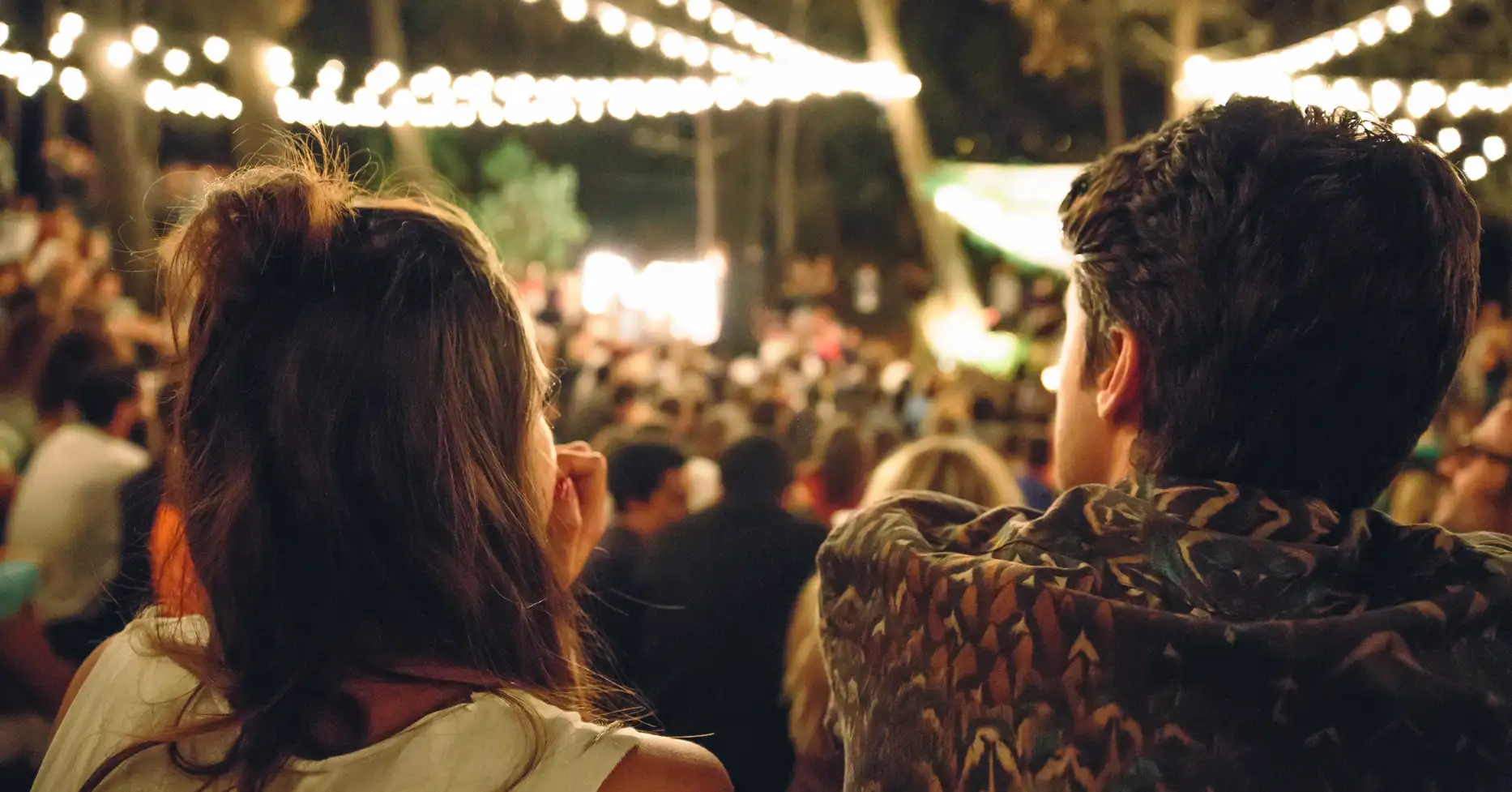 Couple enjoying outdoor event at night