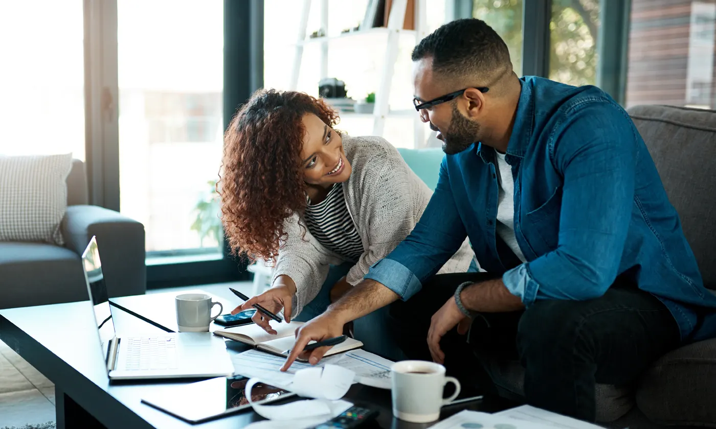 Couple at home working on balancing accounting books