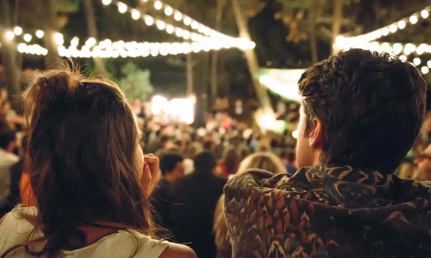 Couple enjoying outdoor concert event at night
