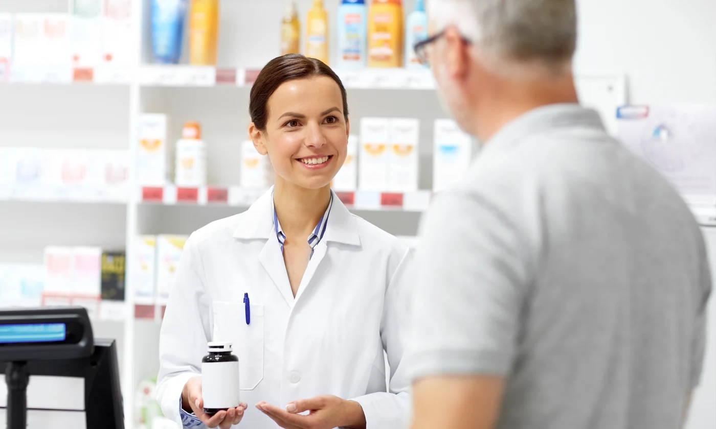 Pharmacist helping customer with medication in pharmacy