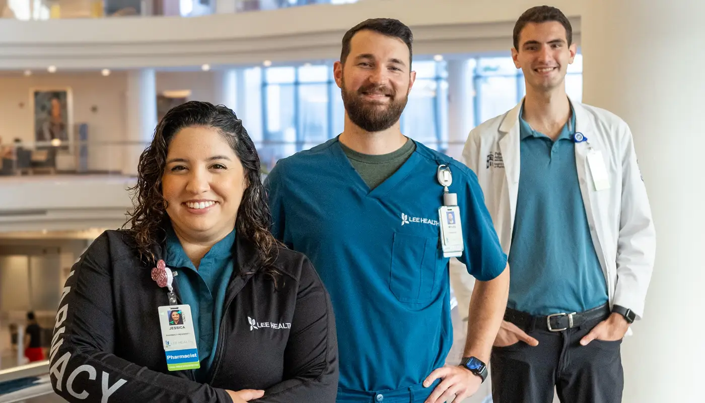 Three pharmacists standing in hospital lobby